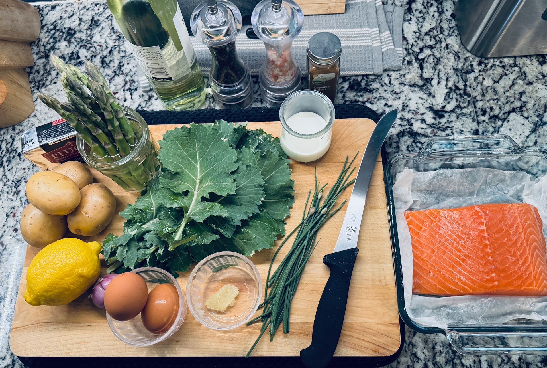 Prep for oven poached salmon featuring Kale, Asparagus and fresh snipped chives from the spring garden.
