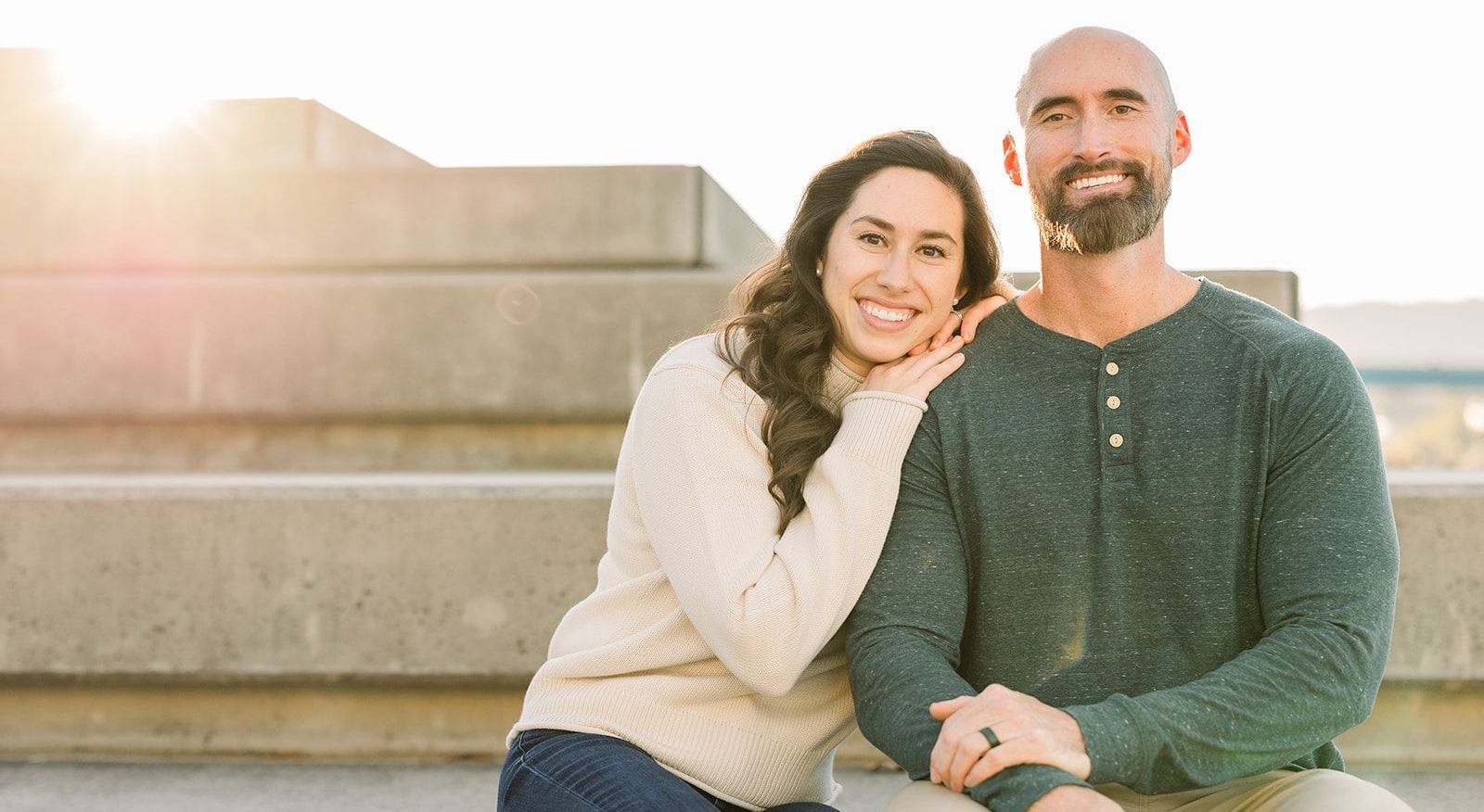 A man and a woman are sitting next to each other on a bench.