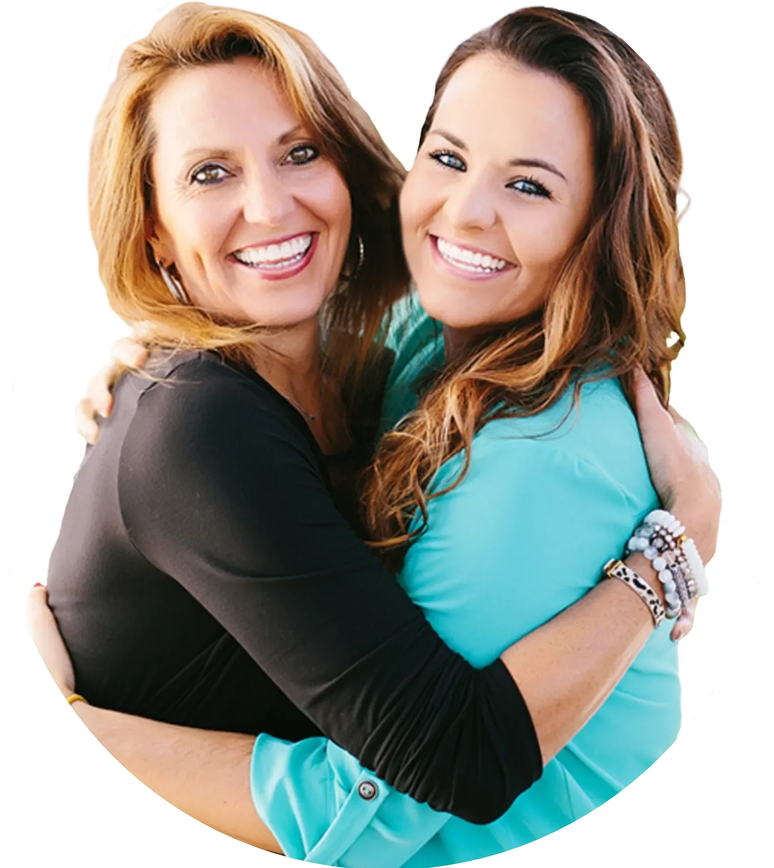 Two women hugging, one has clear braces on her teeth