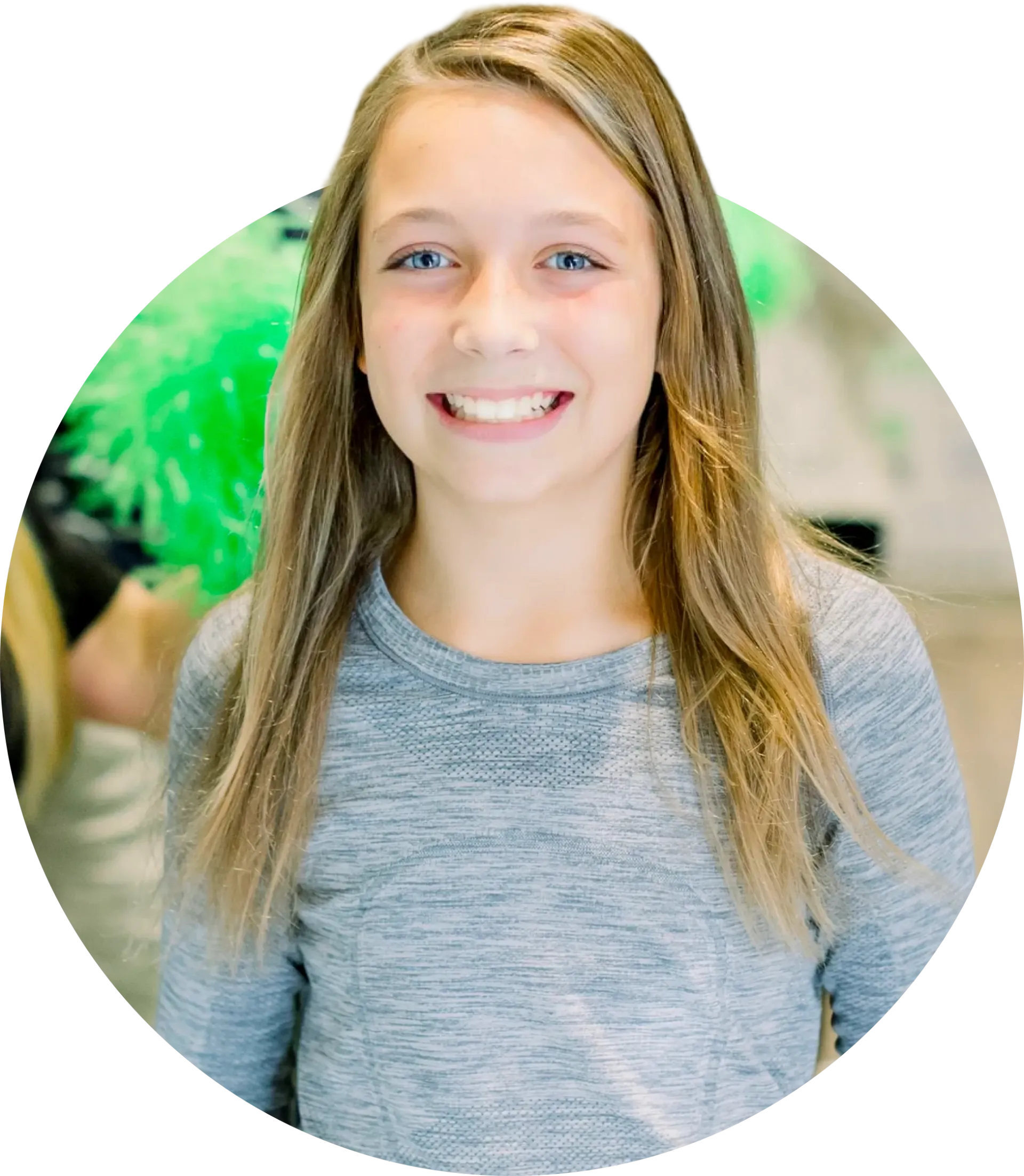 A young girl is smiling for the camera in a circle.