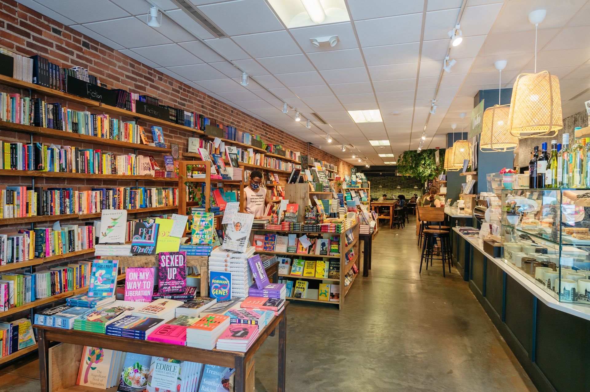 A bookstore filled with lots of books on shelves and tables.