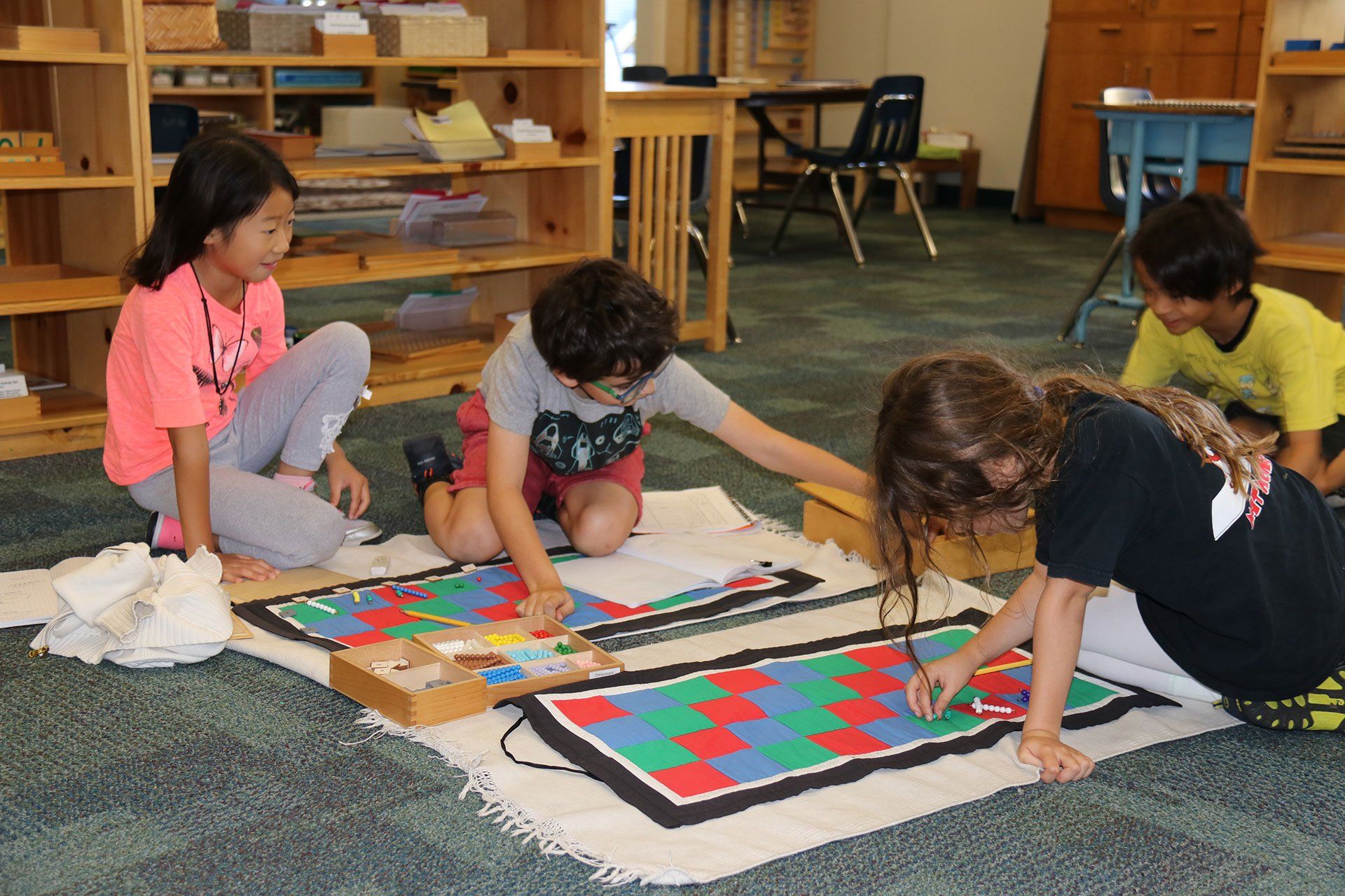 Lower elementary students collaborating on the checker board