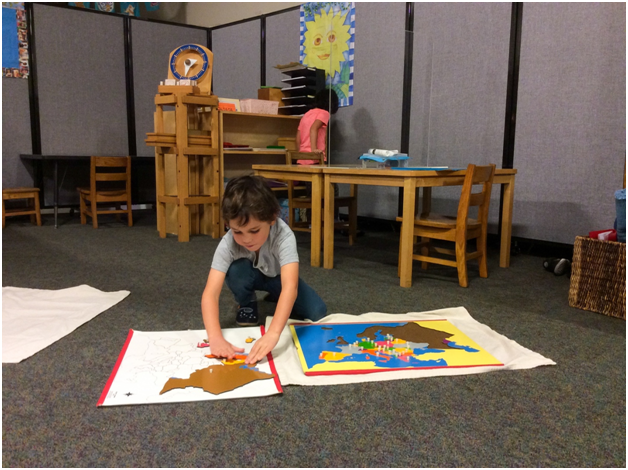 Kinder Student working with a Montessori Map Puzzle
