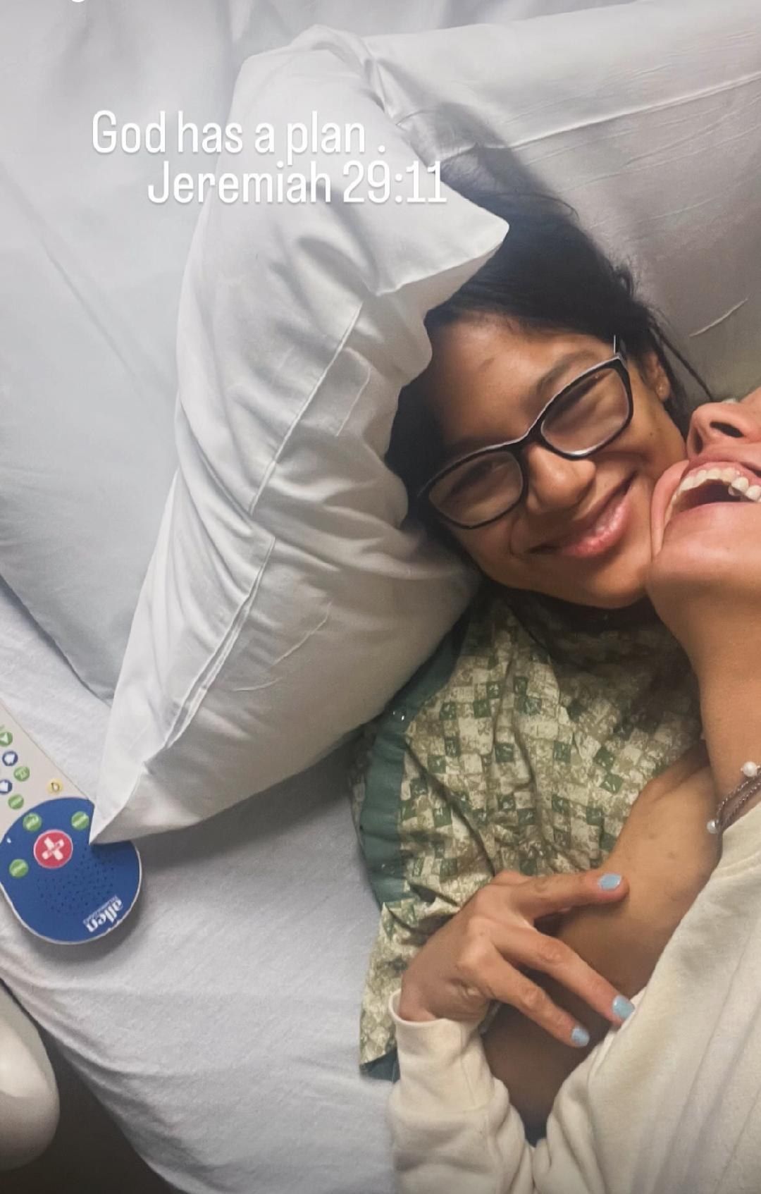Two people smiling together in a hospital bed, with a hospital television remote visible nearby and text about a plan.