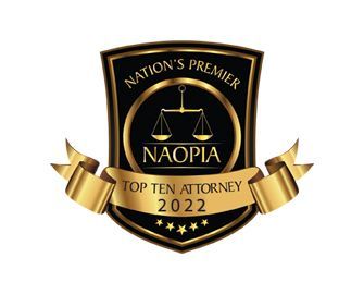 Black and gold NAOPLA Top Ten Attorney 2022 award badge with scales of justice and banner.
