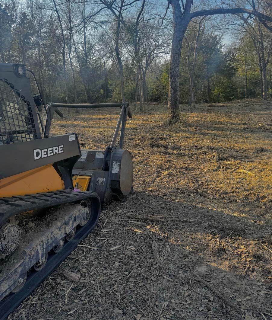 A bulldozer is sitting in the middle of a field.