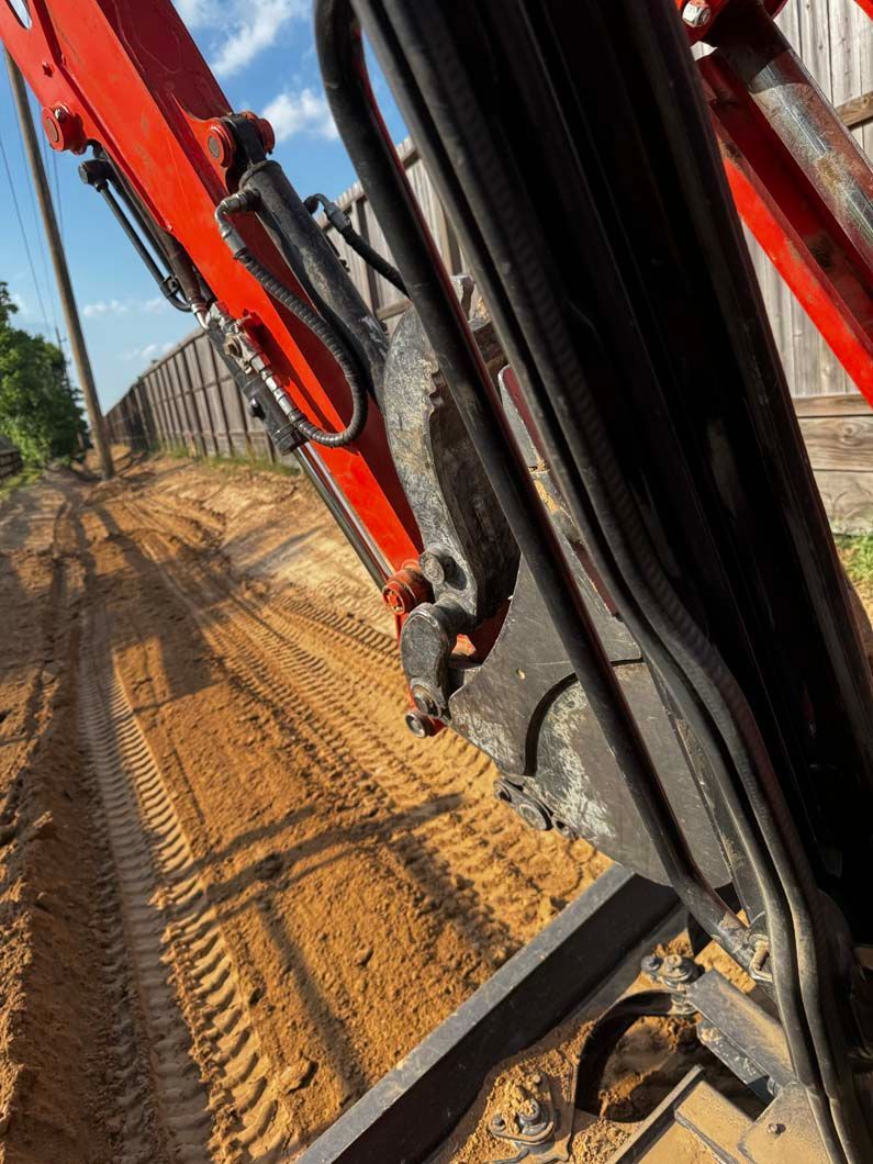 A close up of an excavator on a dirt road.