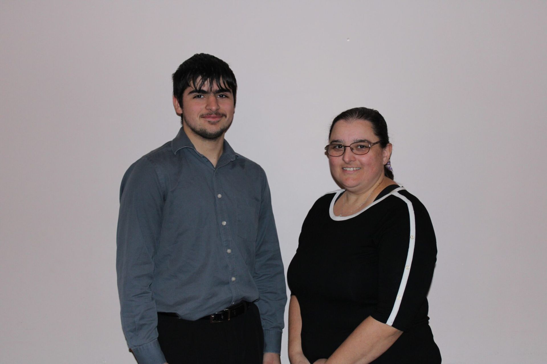 A man and a woman are posing for a picture together
