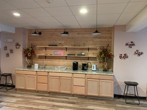 A kitchen with wooden cabinets and a wooden wall.