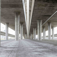 Empty concrete underpass with columns and a wide roadway receding into the distance