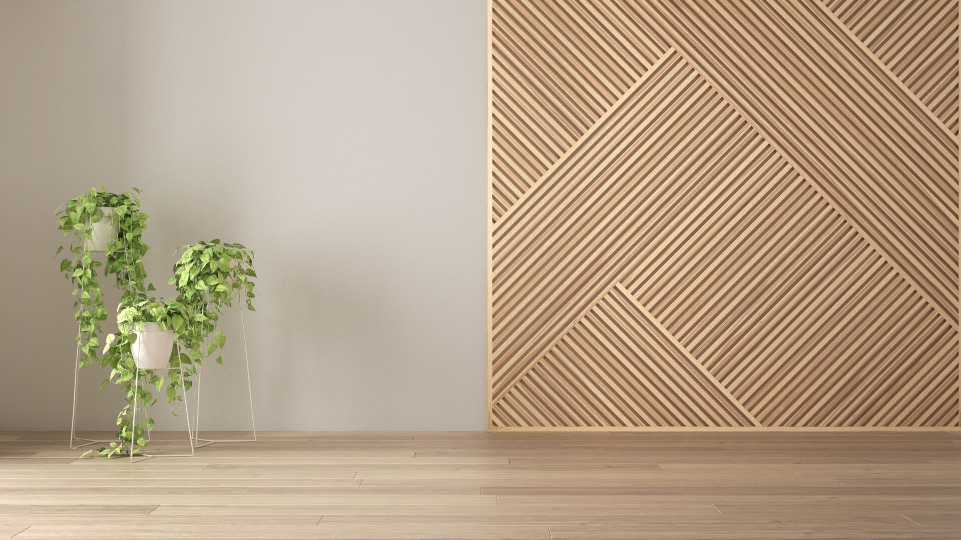 There is a plant in a glass vase on a wooden table in front of a wooden wall.