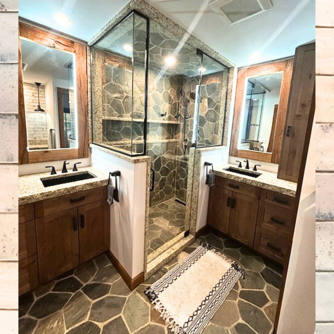 Rustic bathroom with stone flooring and shower, flanked by two vanities.