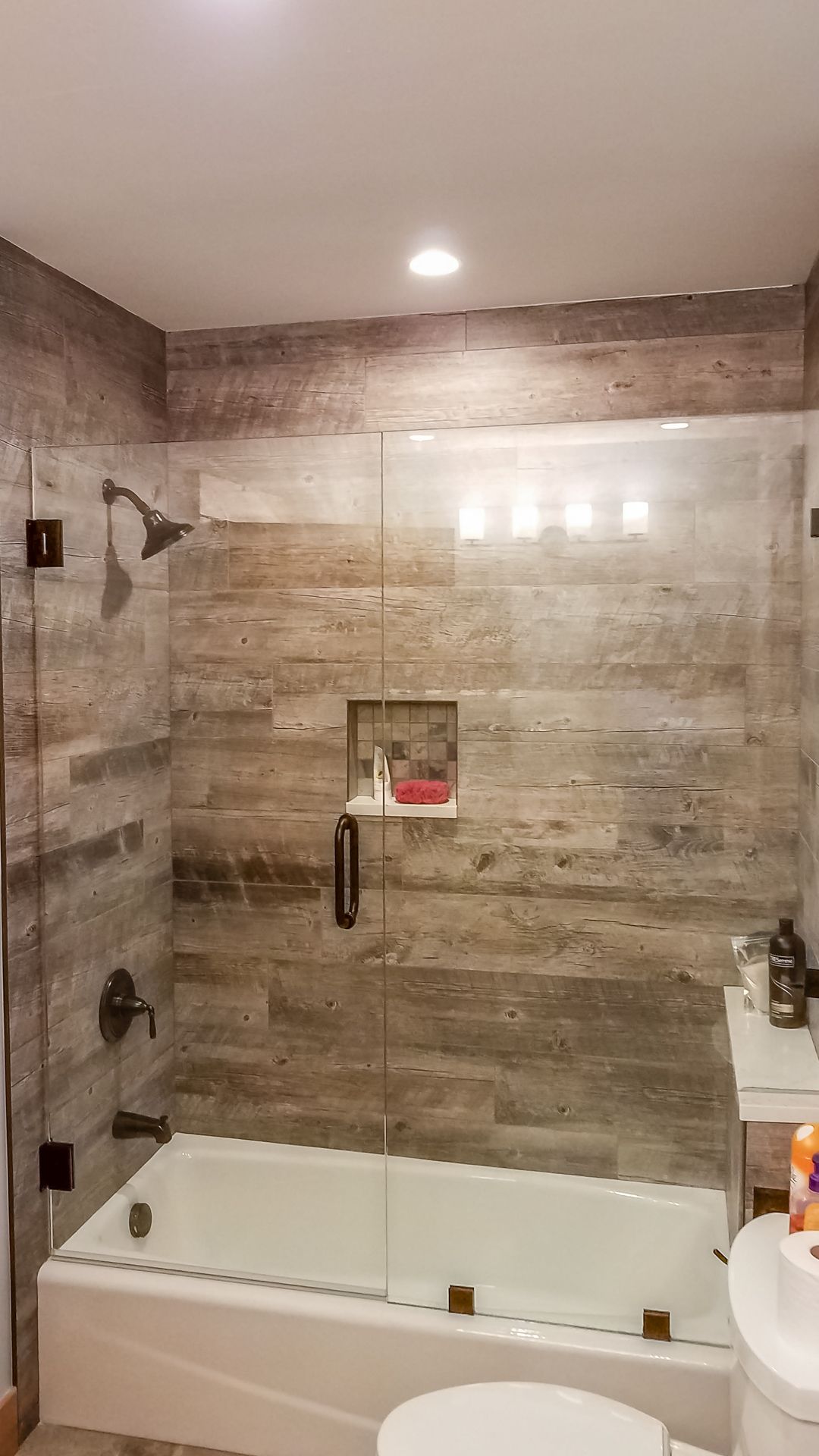 Bathroom with a bathtub and shower combination.