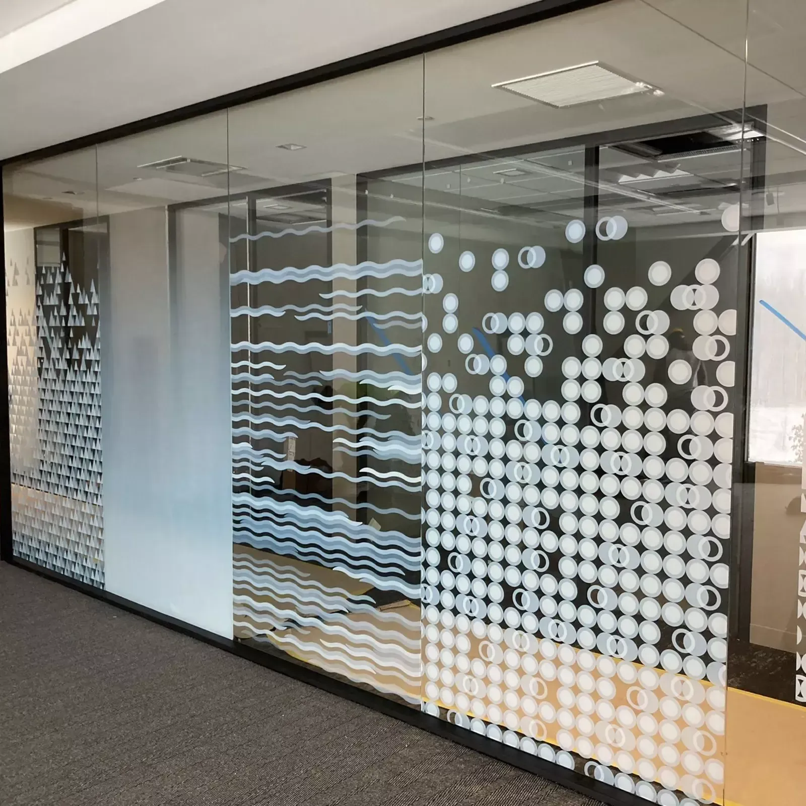Glass office walls with decorative frosted patterns in a variety of shapes and designs.