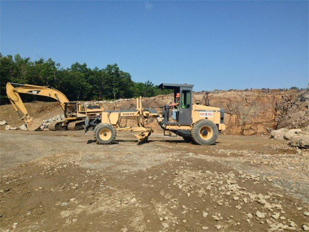 Worker Using Construction Truck — Bangor, ME — Hughes Bros Inc