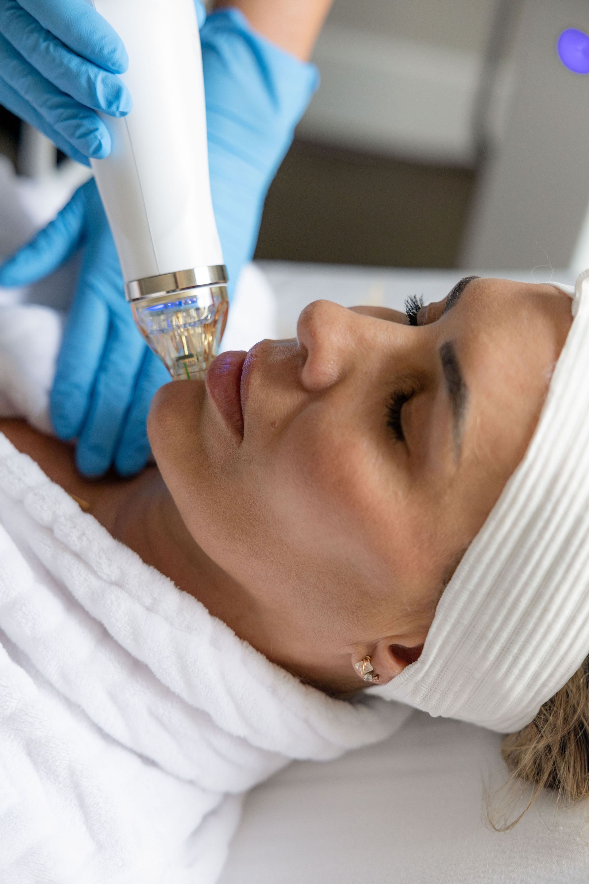 A woman is getting a facial treatment at a beauty salon.