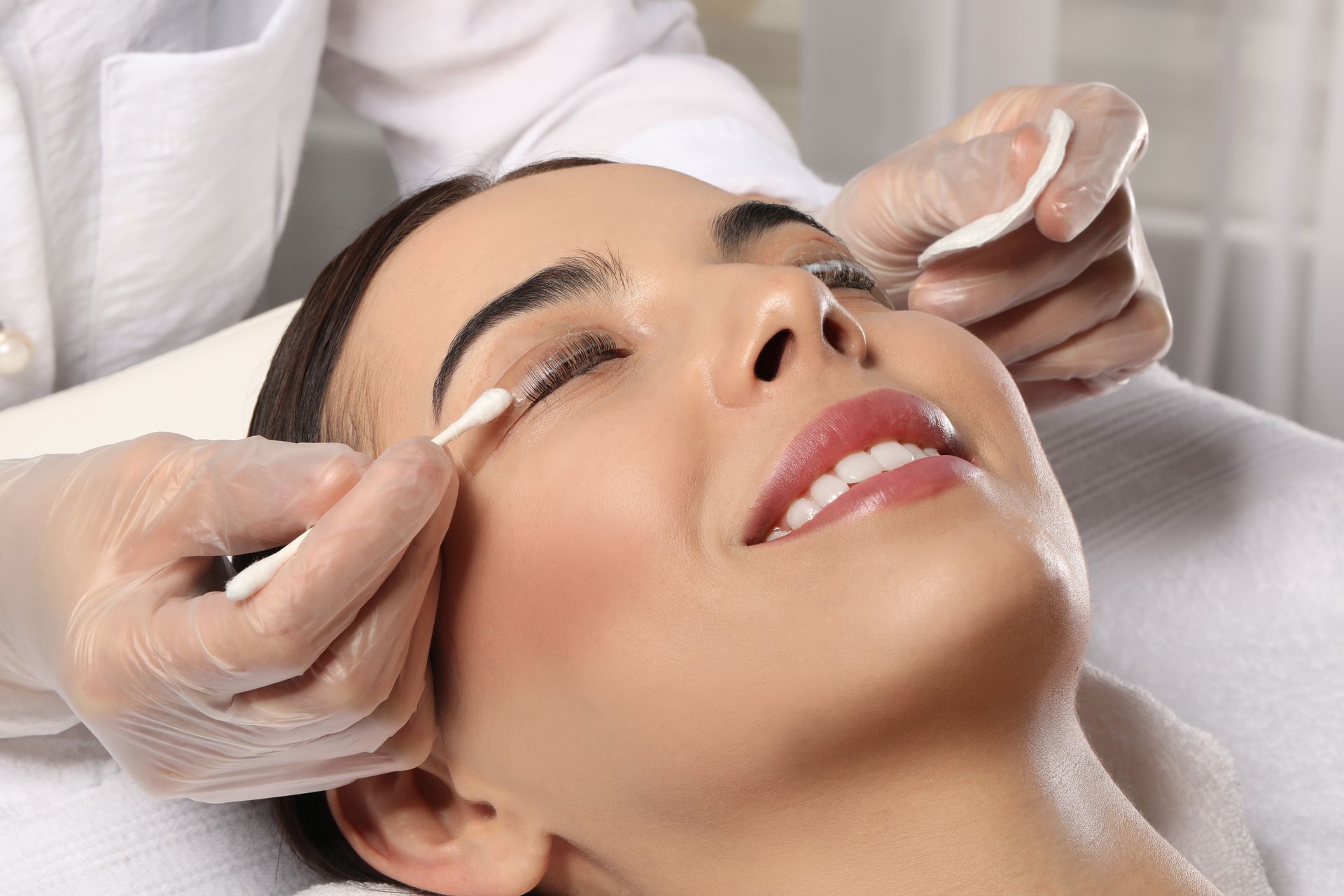 A woman is getting a facial treatment at a beauty salon.