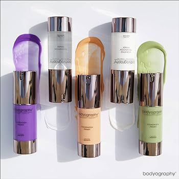 Four bottles of bodyography foundation are sitting next to each other on a table.