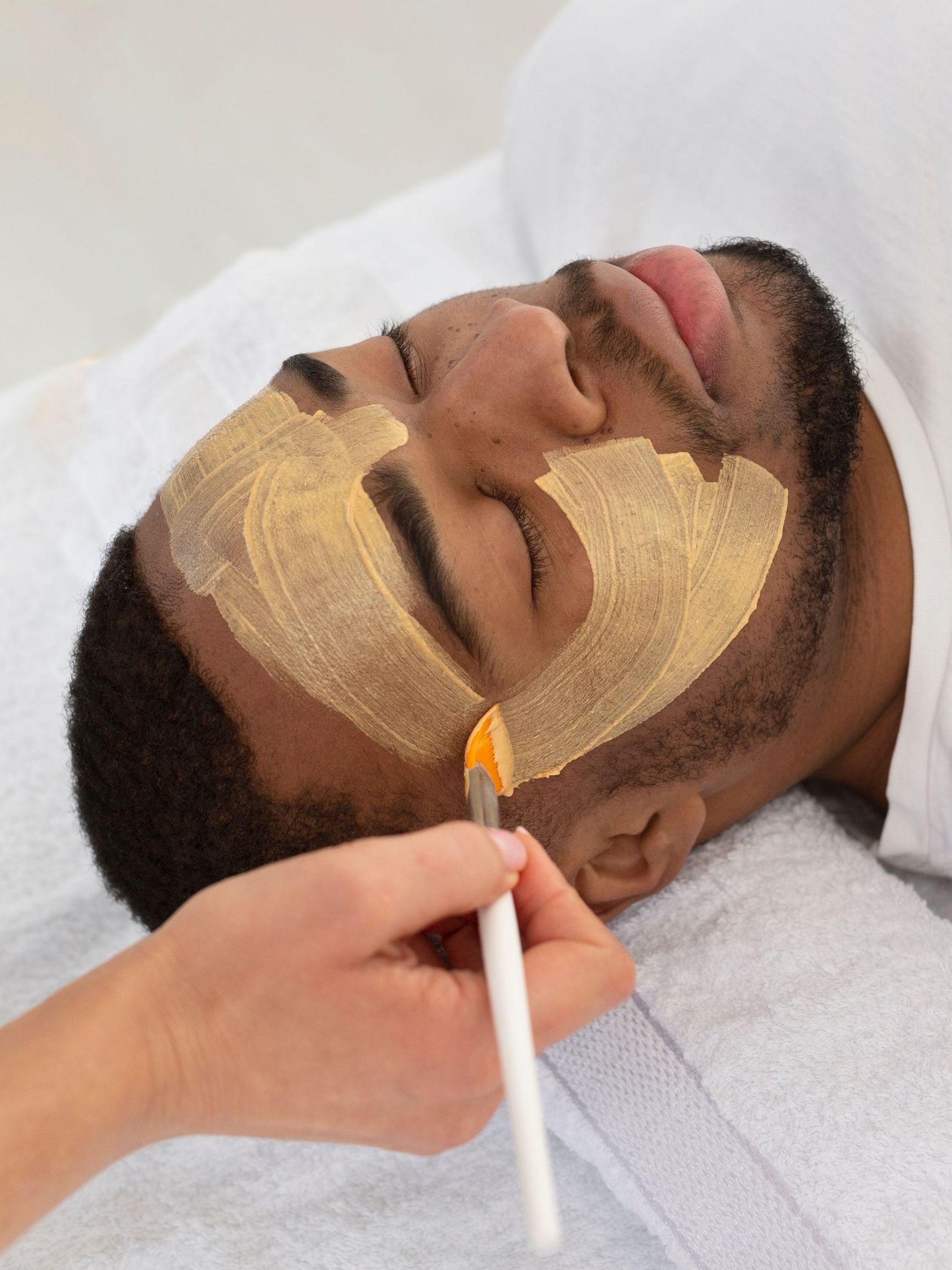 man receiving facial treatment procedure
