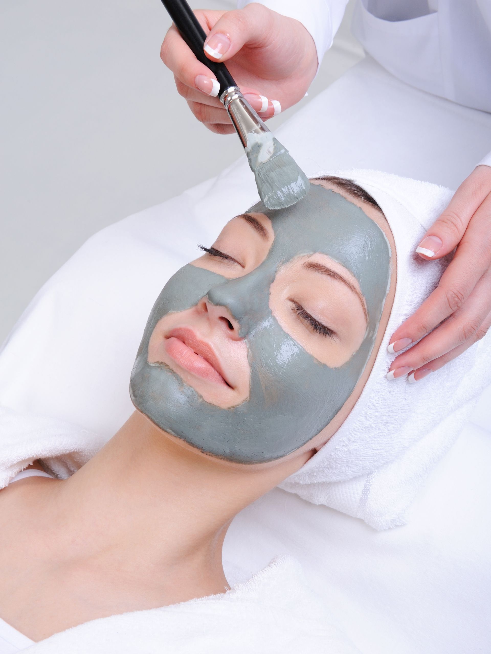 woman receiving clarifying facial treatment procedure