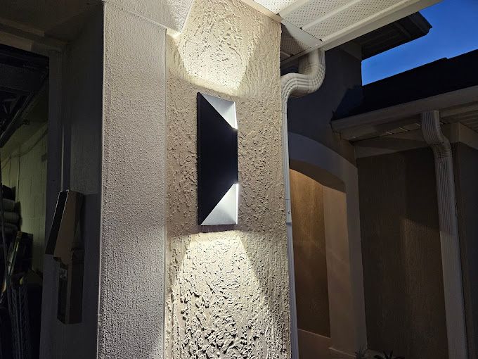 There is a light on the side of a building.