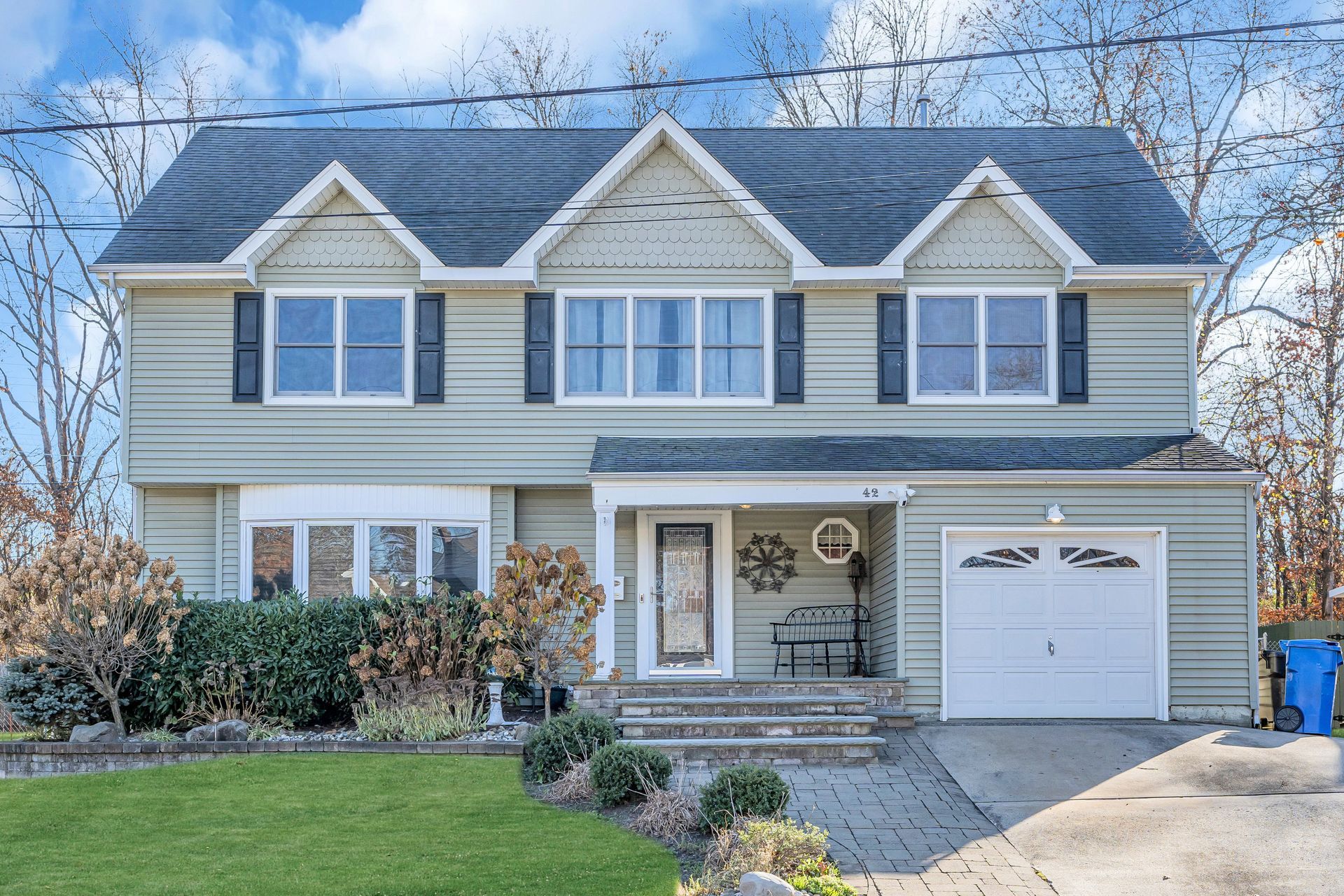 A large house with a garage and a lot of windows