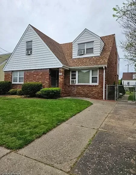 A brick house with a white siding and a brown roof is for sale.