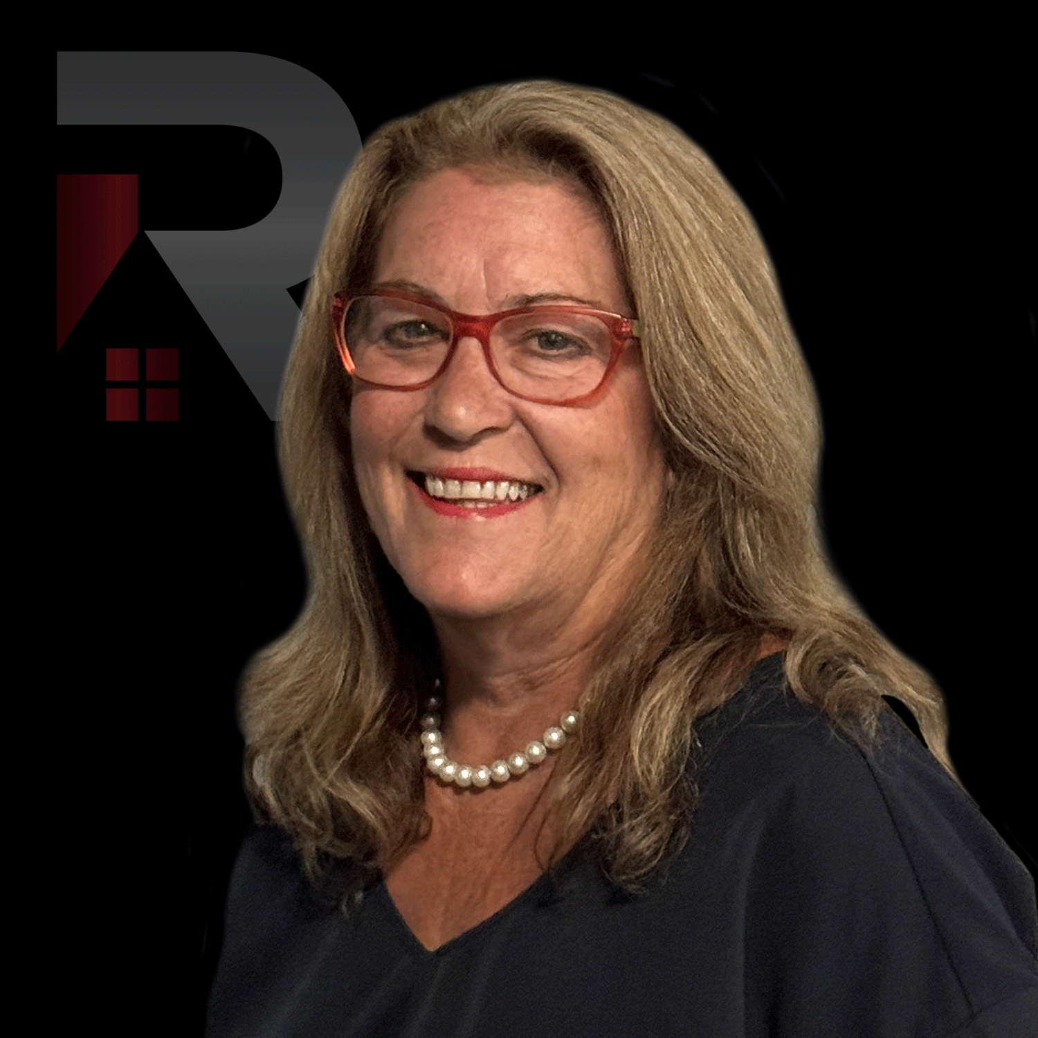 Linda Jay wearing glasses and a pearl necklace is smiling.