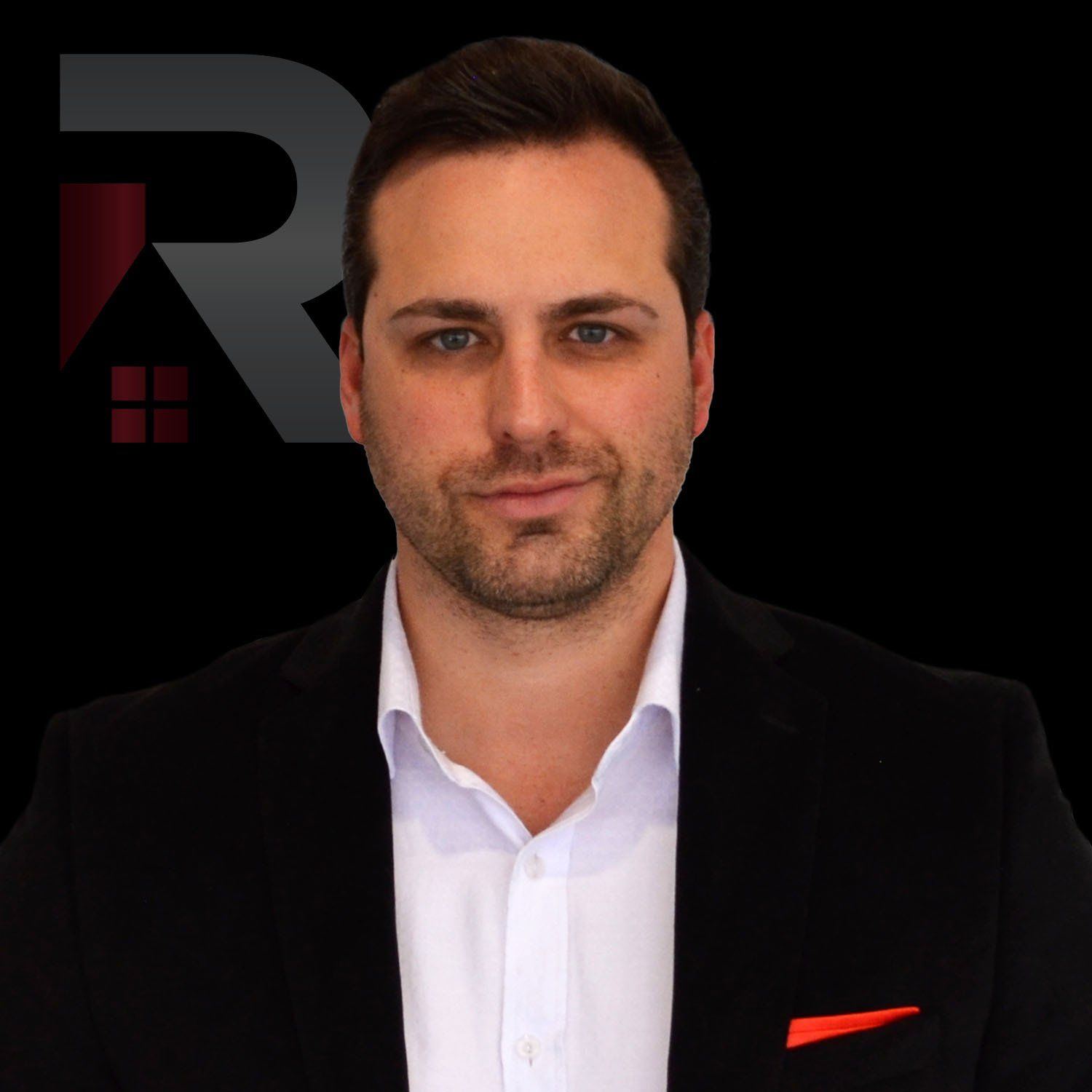 Kristopher W. Brus in a suit and white shirt with a red pocket square.