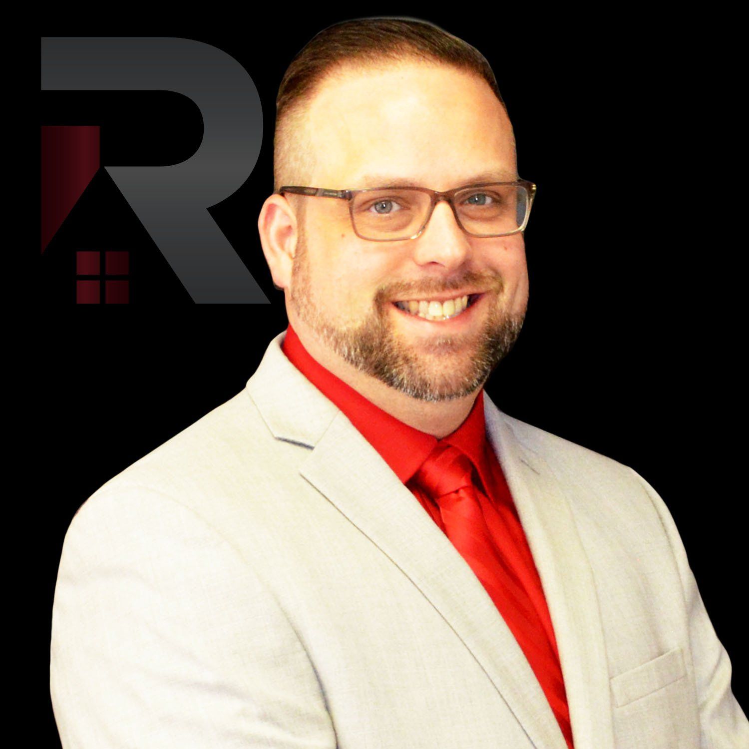 Micheal Brus wearing glasses and a red shirt is smiling for the camera.