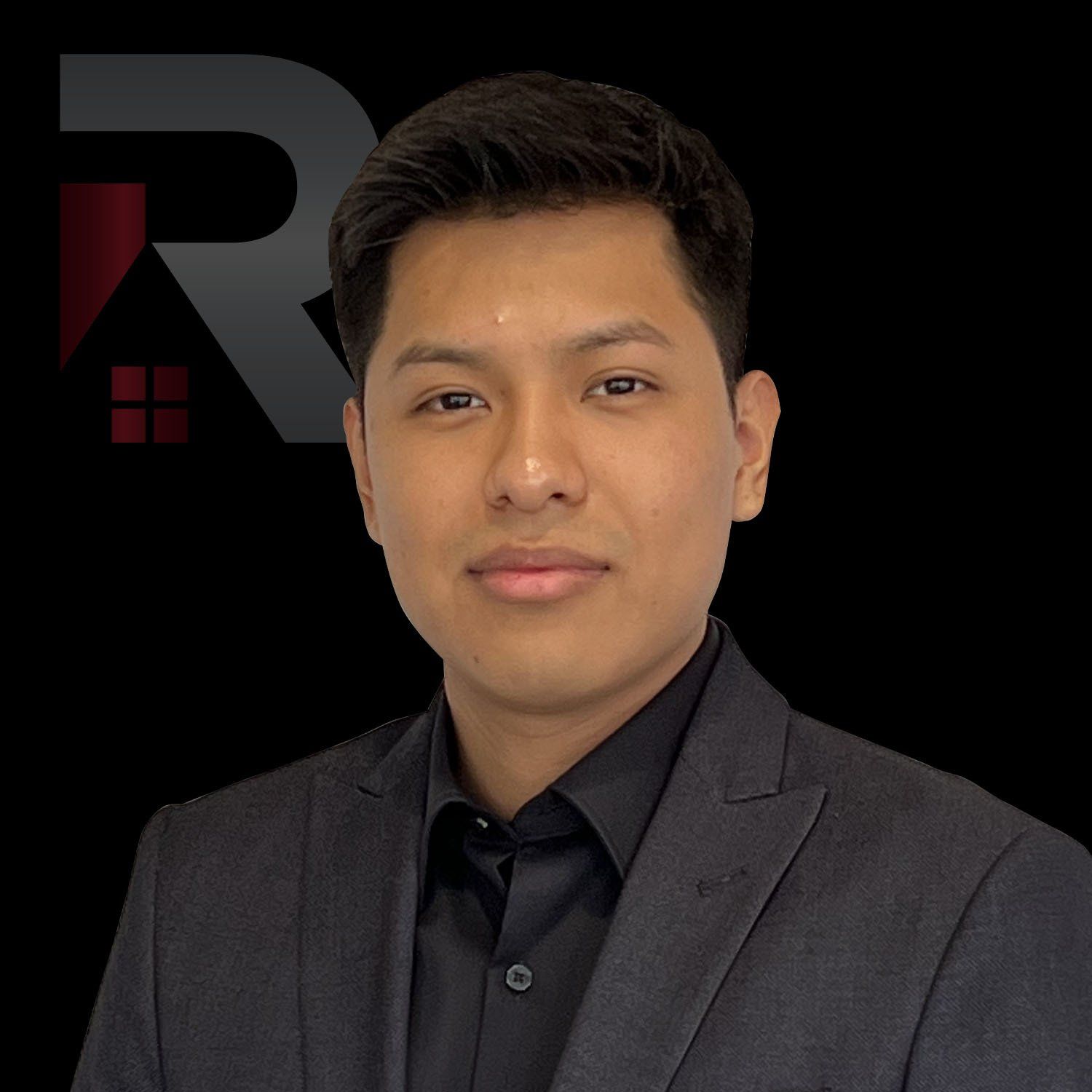 Oscar Olivos in a suit and black shirt is standing in front of a black background.