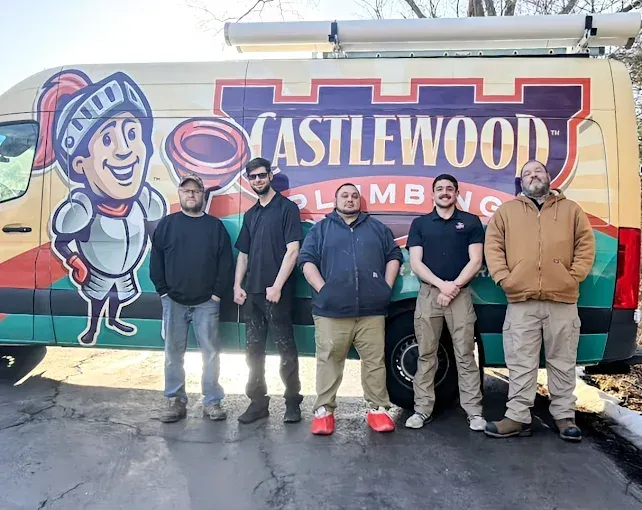 Hands being washed under running water in a kitchen sink.