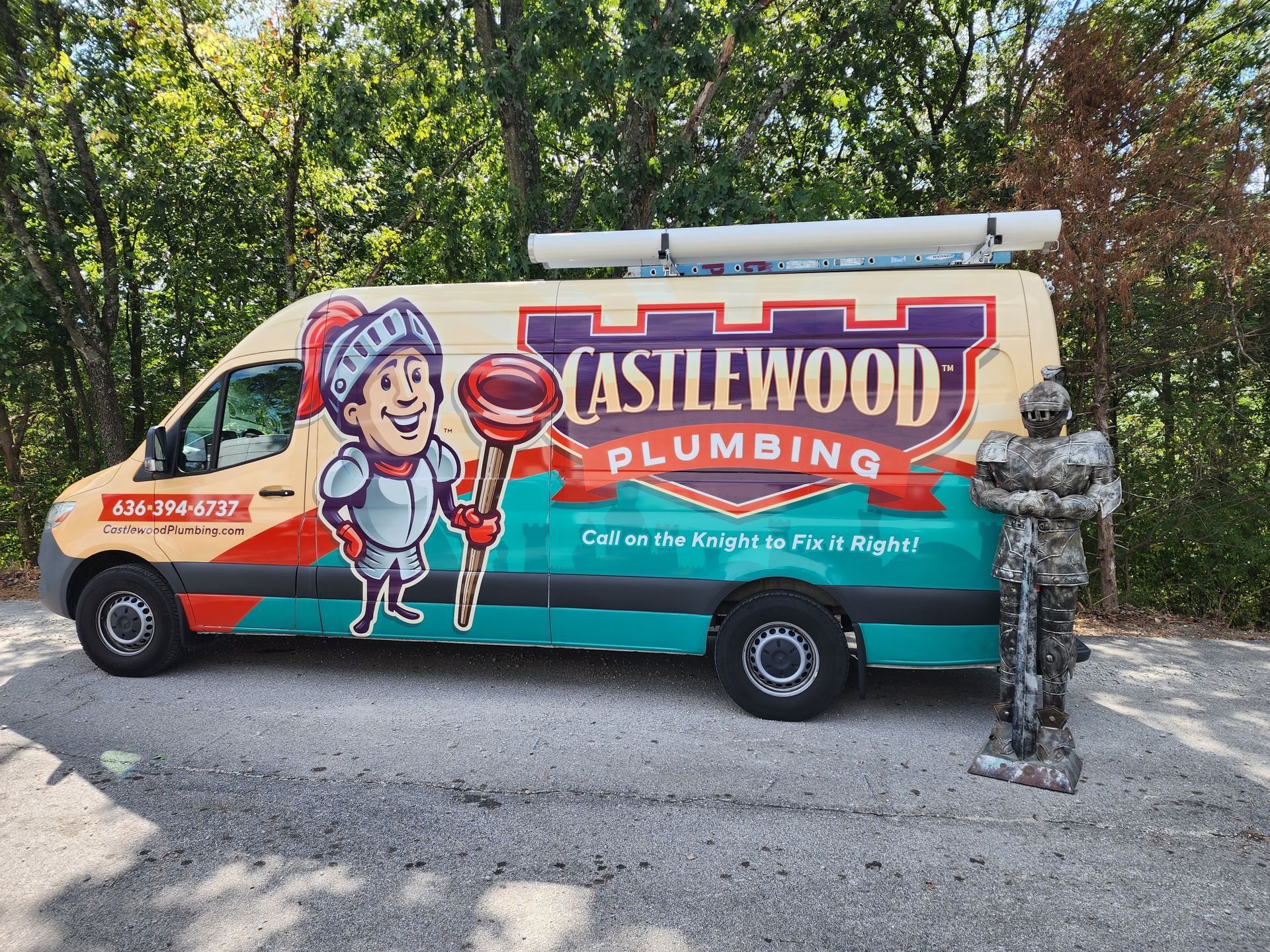 Castlewood Plumbing van with cartoon knight mascot holding lollipop; parked on gravel road.