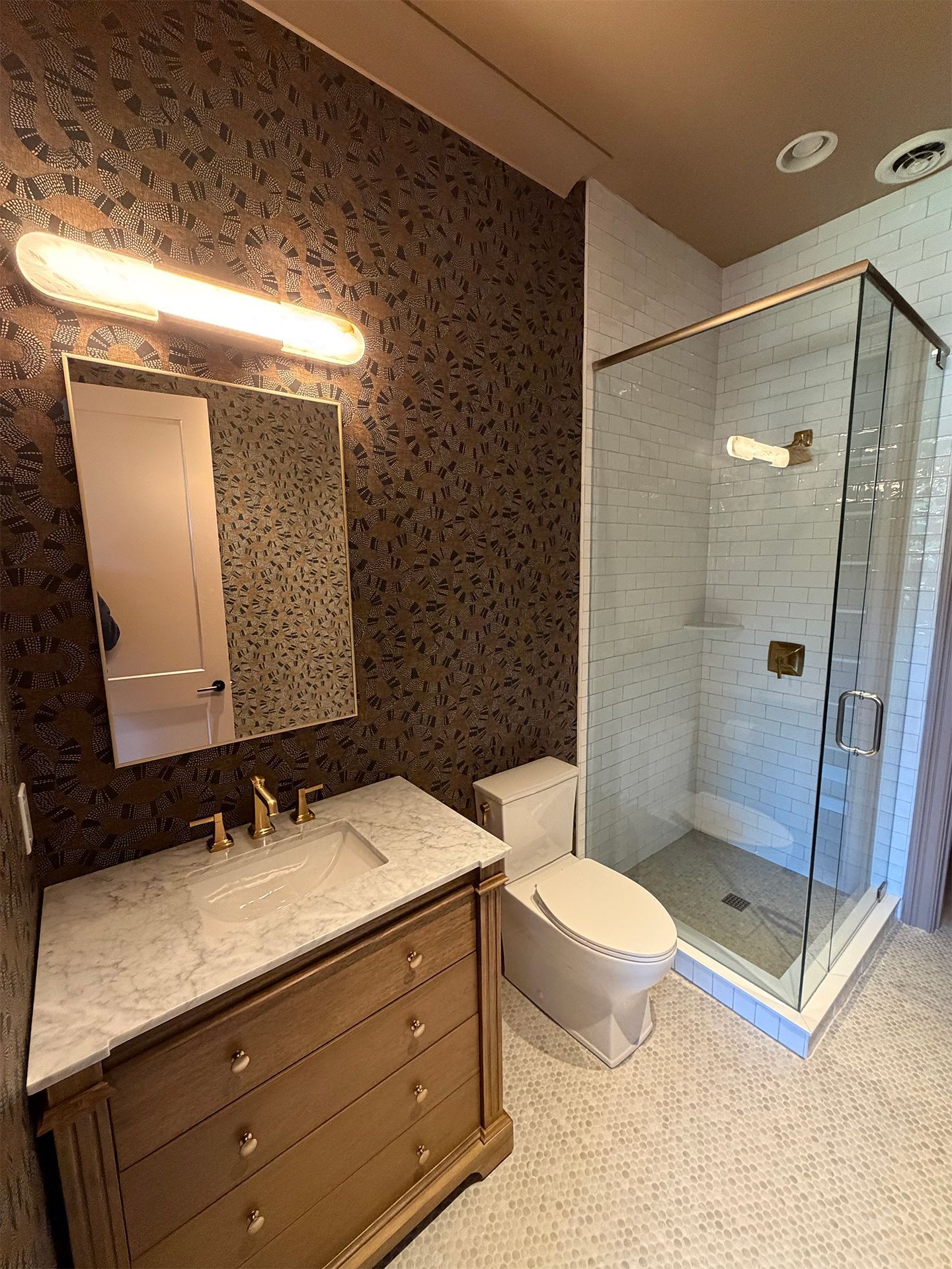 Modern bathroom with vanity, mirror, toilet, and glass shower enclosure