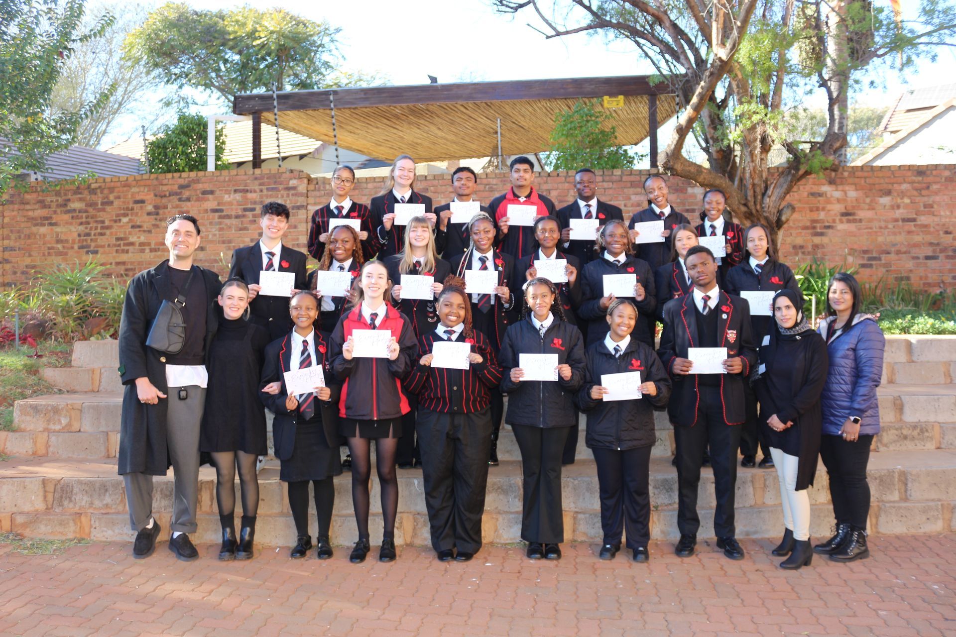 A group of people standing next to each other holding certificates.