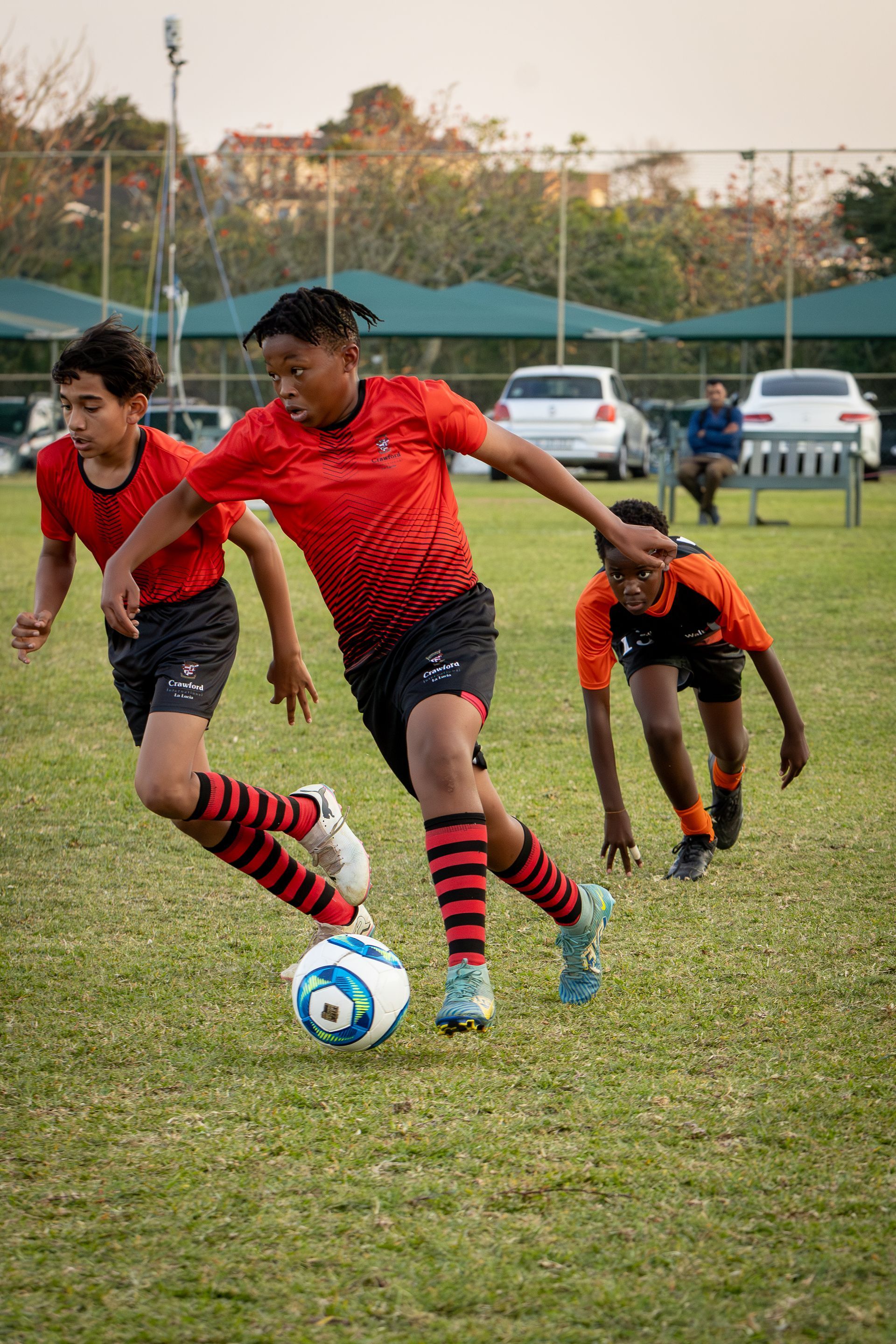 A group of young boys are playing soccer on a field.