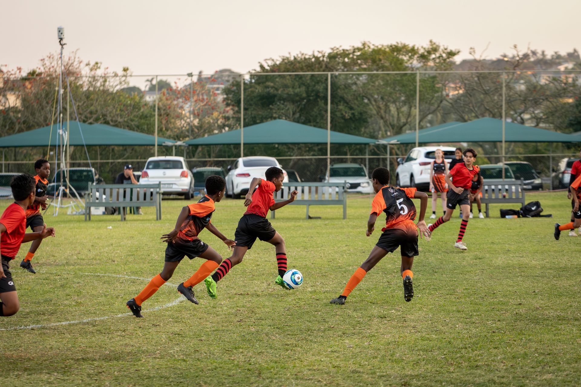 A group of young boys are playing soccer on a field.