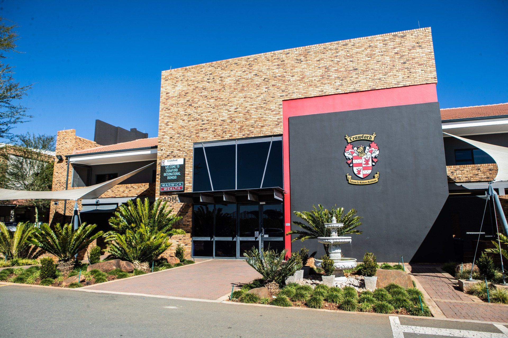 A large building with a coat of arms on the side of it