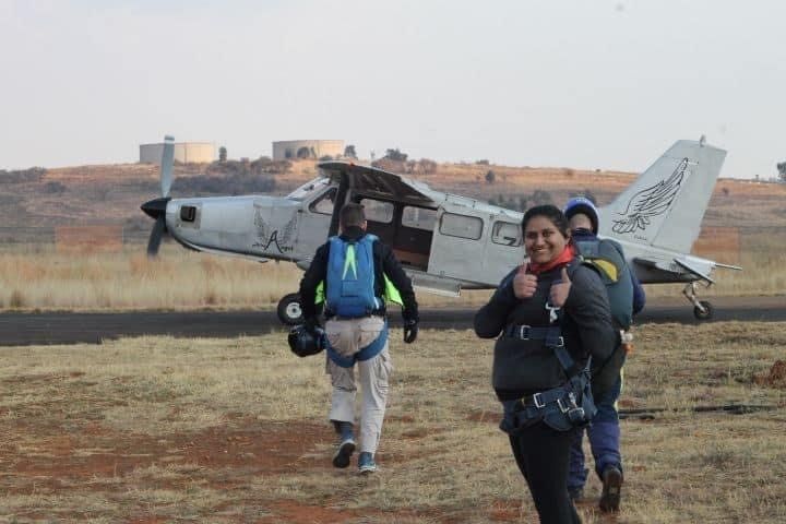 A group of people are walking towards a small plane.