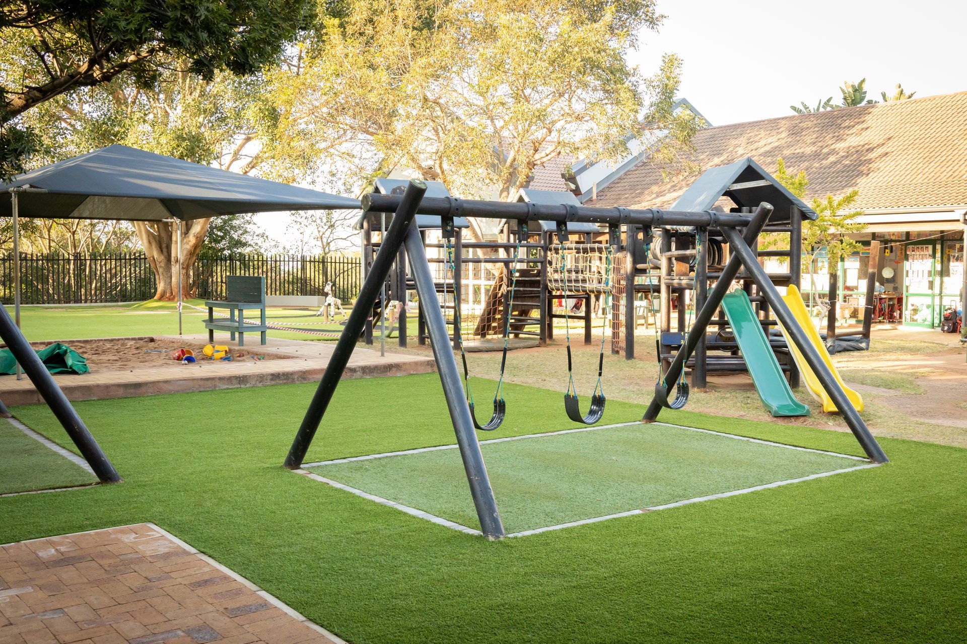 a toy truck and buckets are in a sandbox .