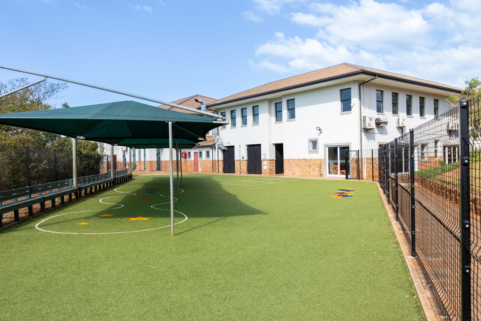 a large building with a playground in front of it .