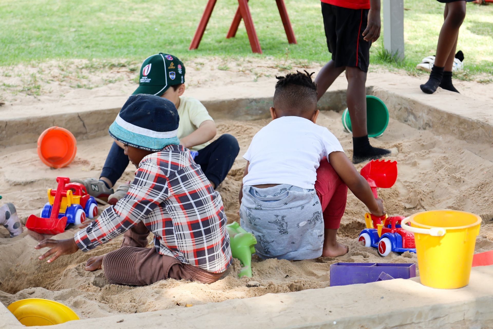 a group of children are playing in a sandbox .