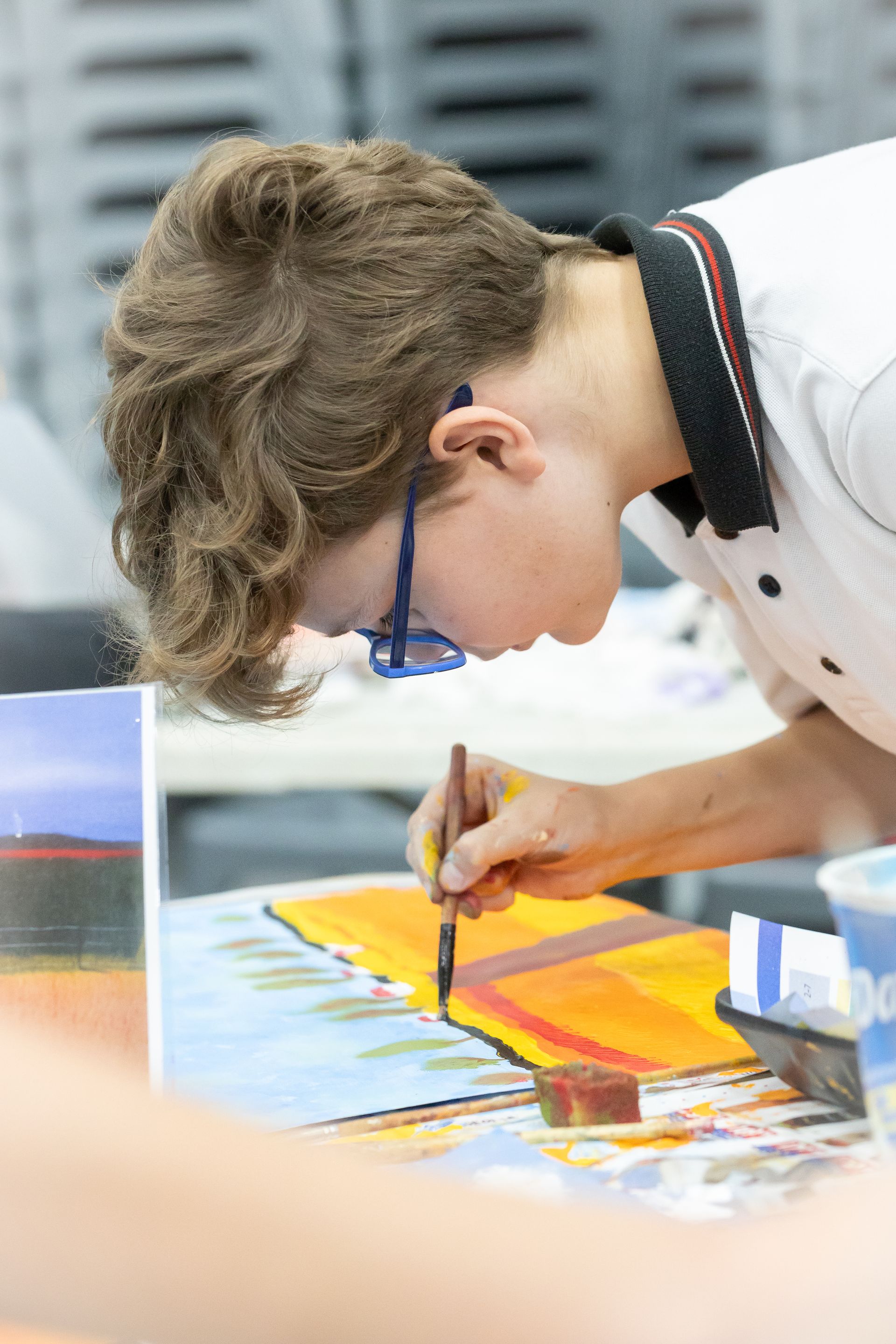 a painting of a sea turtle is on an easel next to a stuffed turtle .
