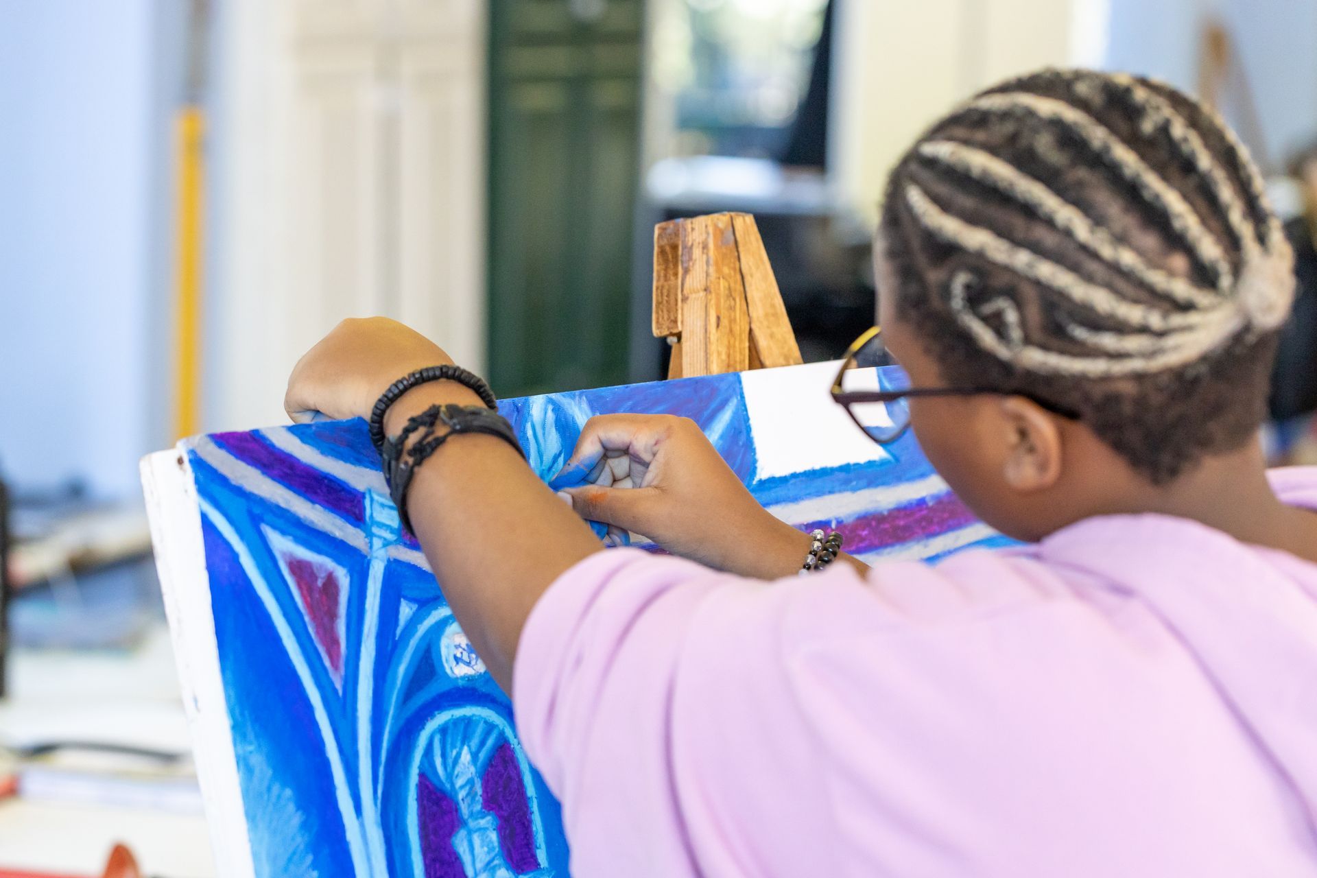 a row of colorful art pieces hanging from the ceiling