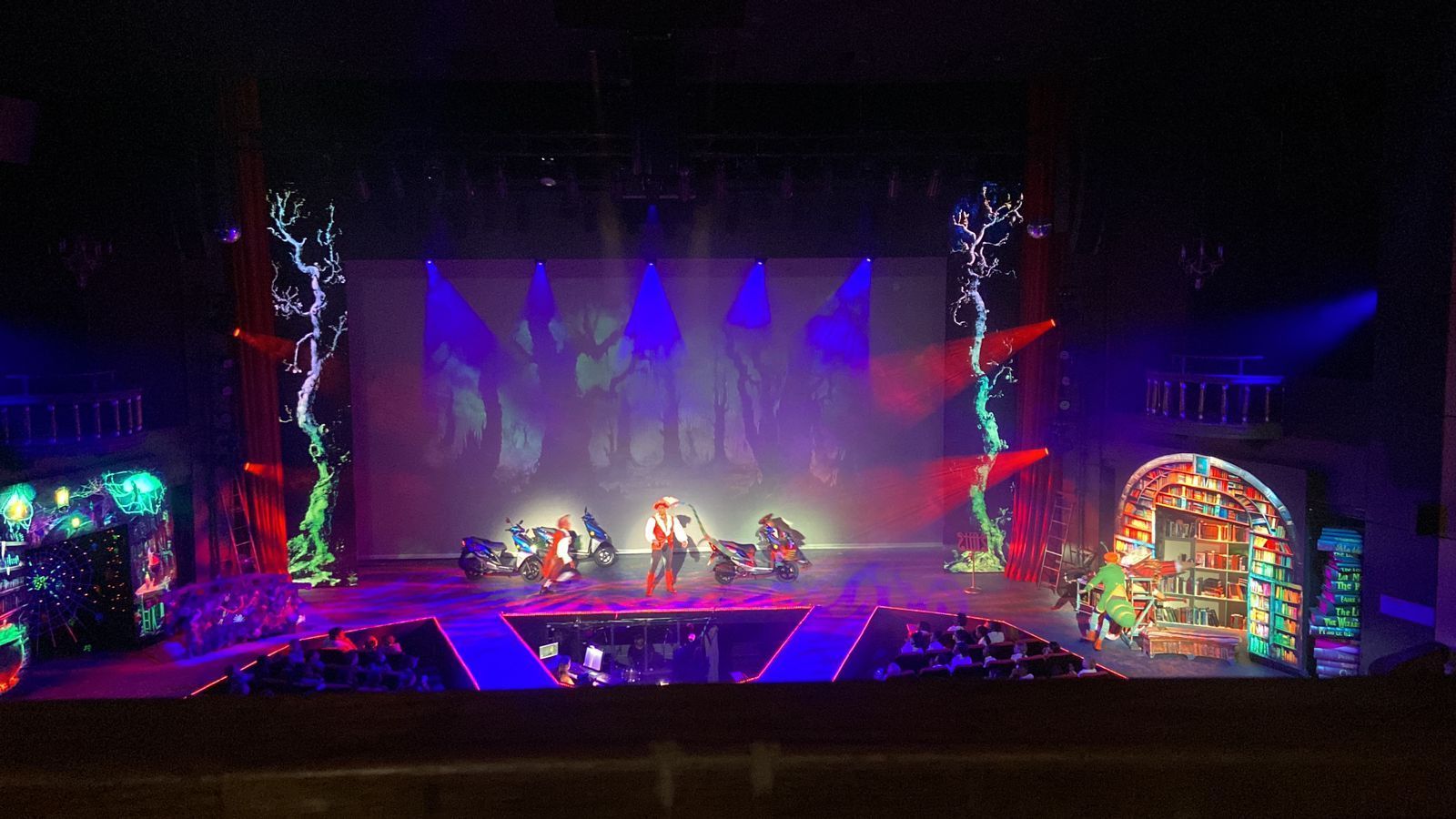 A stage with a lot of lights on it and a group of people on it.