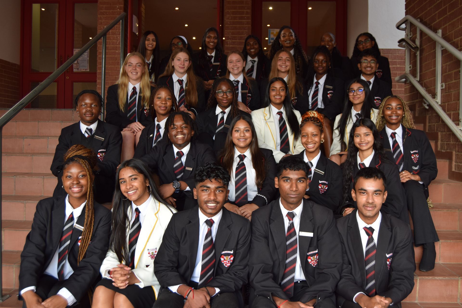 A group of people in suits and ties are posing for a picture.