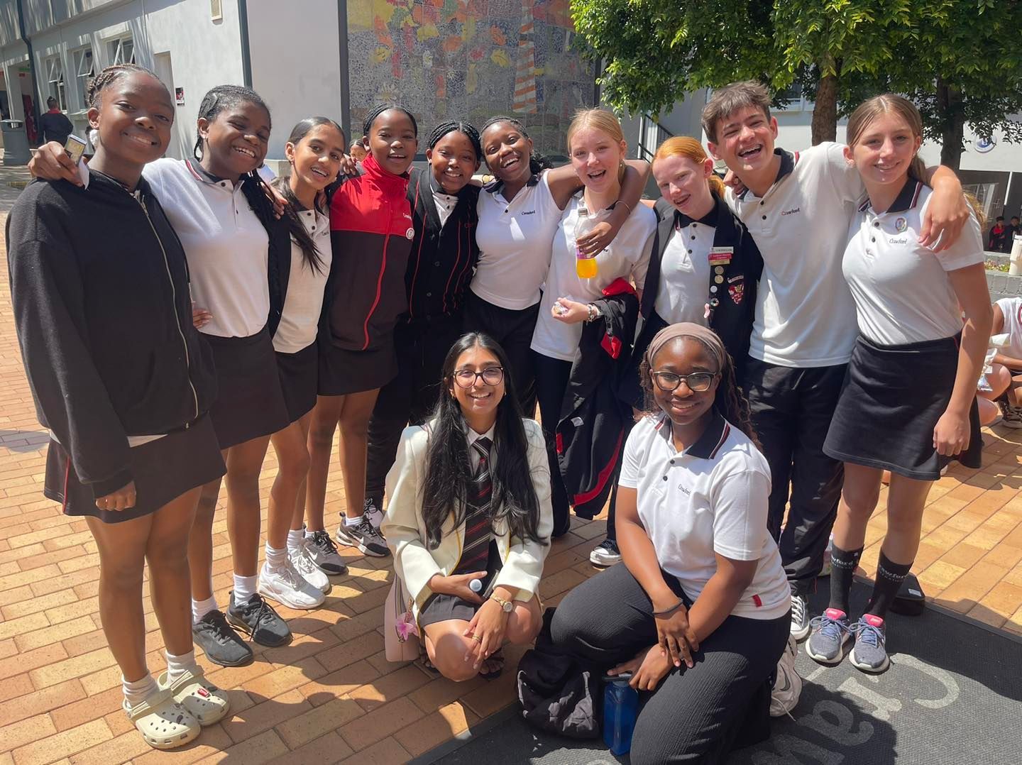 A group of young people are posing for a picture.