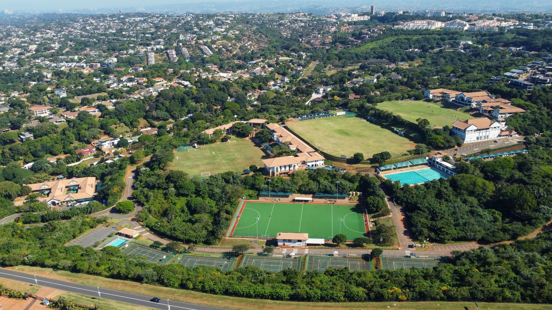 an aerial view of a soccer field with a house in the background .