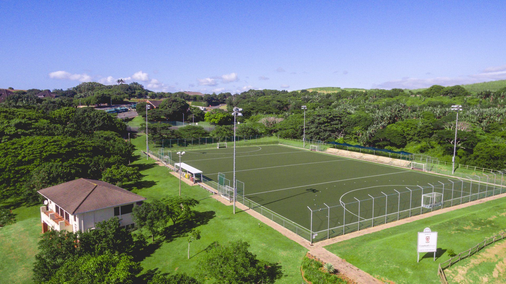 an aerial view of a sport field with a building in the background .