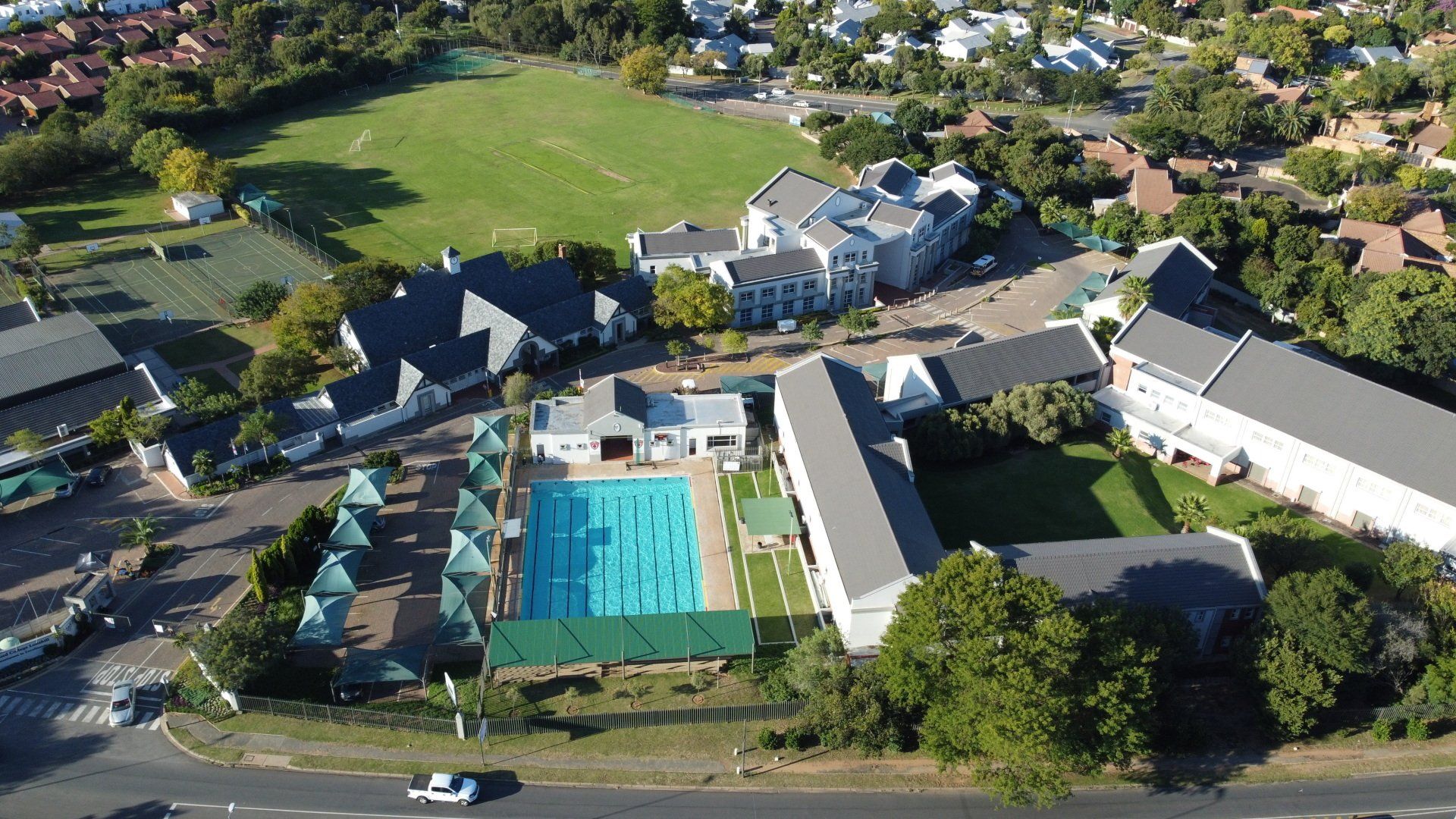 an aerial view of a swimming pool in the school